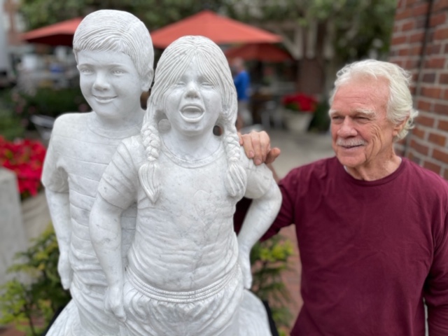 Sculptor Don Reynolds alongside his masterpiece