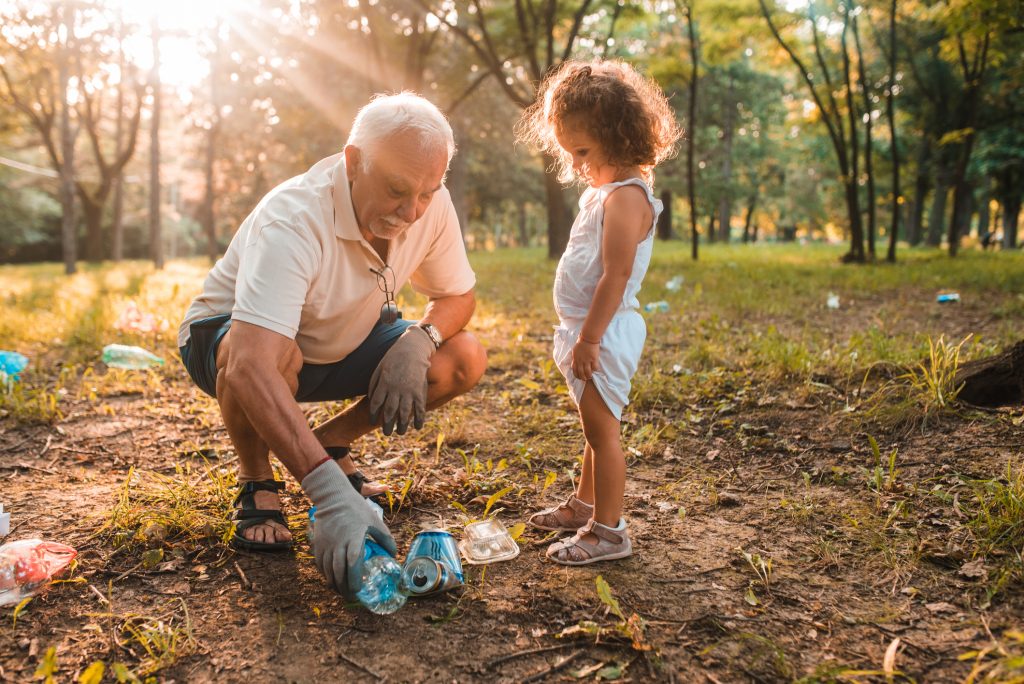 Grandfather and granddaughter recycling