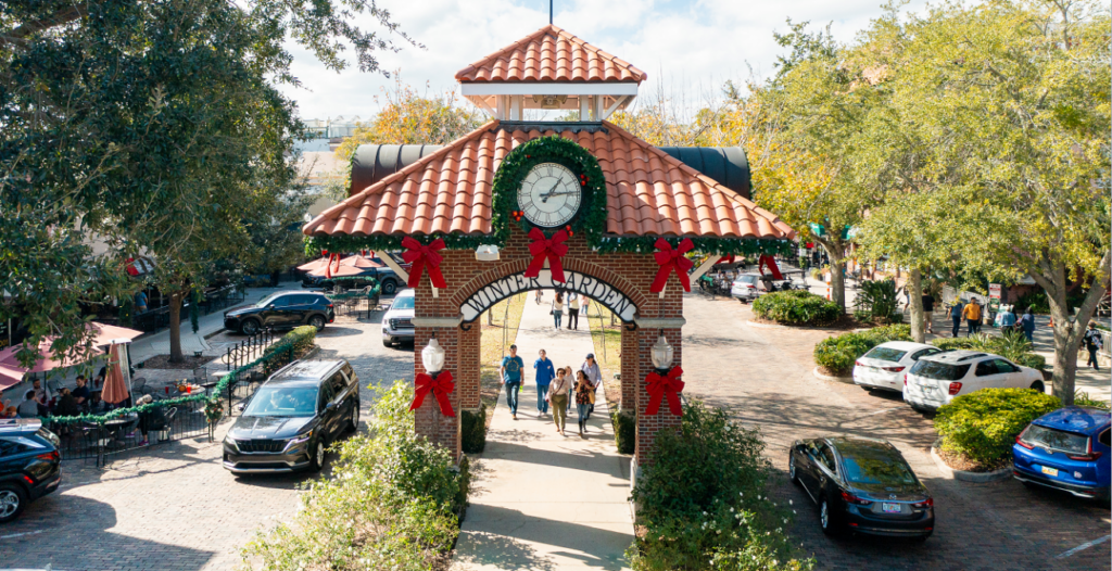 Aerial view of clock tower in downtown winter garden with christmas decor and pedestrians walking around