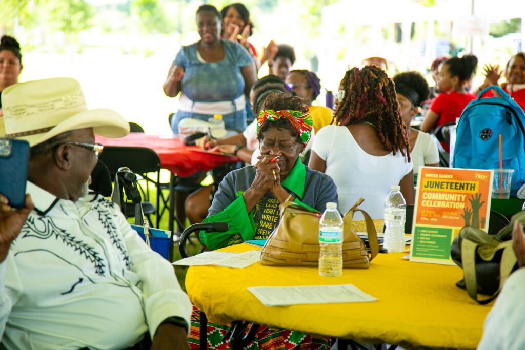 photo of groups of people under tent celebrating Juneteenth