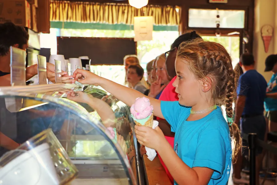 Child choosing ice cream at a downtown sweet shop