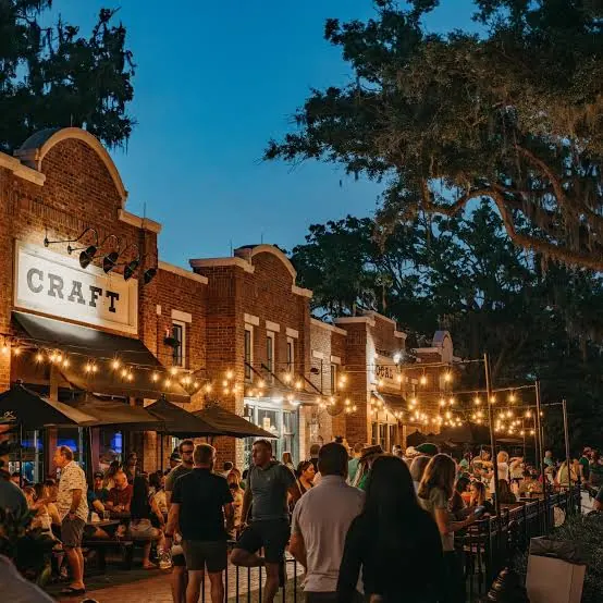 Crowd at a downtown brewery patio under string lights