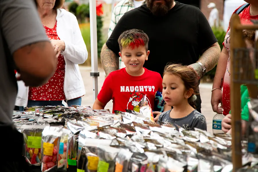 Shoppers browsing vendor tables at the Holiday Night Market